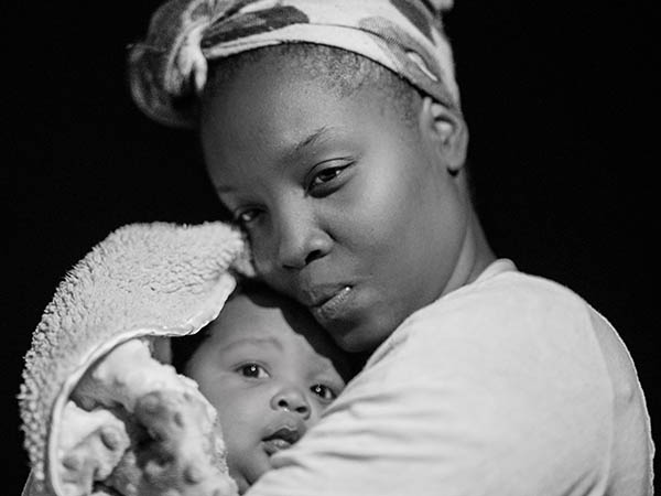 Black mother holding infant child