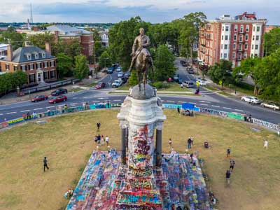 robert e. lee statue painted with protest graffiti