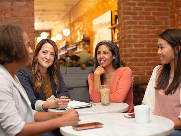 Four women having a business meeting over coffee